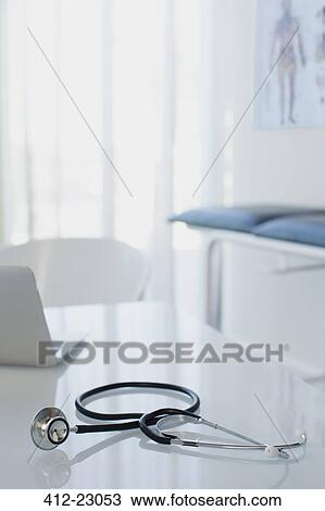 Stethoscope and laptop on white desk in doctors office View Large Photo Image Stock Image - Stethoscope and laptop on white desk in doctors office. Fotosearch