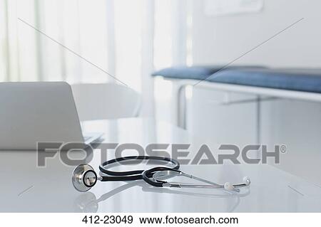 Stethoscope and laptop on white desk in doctors office View Large Photo Image Stock Photo - Stethoscope and laptop on white desk in doctors office. Fotosearch