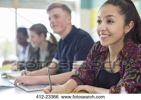 Students in classroom smiling during lesson View Large Photo Image Stock Photograph - Students in classroom smiling during lesson. Fotosearch