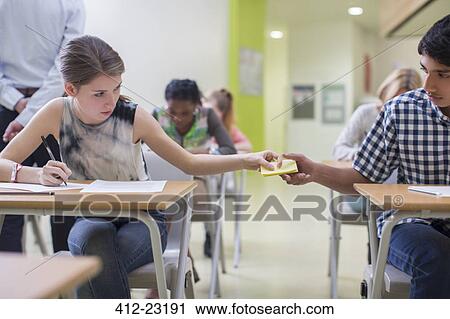 Students passing note between desks during GCSE examination View Large Photo Image Stock Image - Students passing note between desks during GCSE examination. Fotosearch