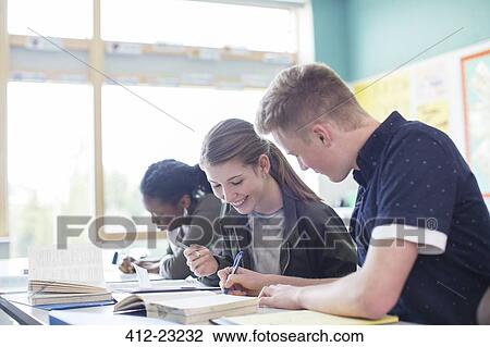 Stock Image - Students sitting in classroom during lesson. Fotosearch