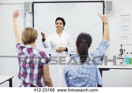 Stock Photograph - Students with their teacher in school lab. Fotosearch