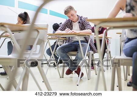 Students writing their GCSE exam in classroom View Large Photo Image Stock Photo - Students writing their GCSE exam in classroom. Fotosearch