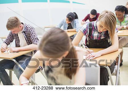Students writing their GCSE exam in classroom View Large Photo Image Stock Photo - Students writing their GCSE exam in classroom. Fotosearch