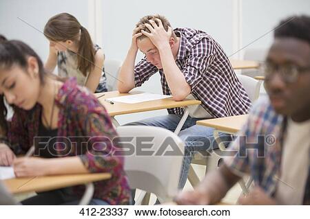 Students writing their GCSE exam in classroom View Large Photo Image Stock Photo - Students writing their GCSE exam in classroom. Fotosearch