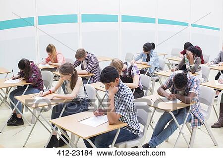 Students writing their GCSE examination in classroom View Large Photo Image Picture - Students writing their GCSE examination in classroom. Fotosearch