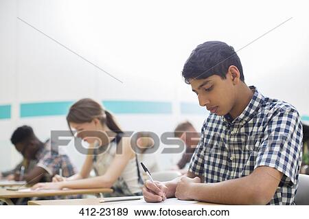 Students writing their GCSE examination in classroom View Large Photo Image Stock Photo - Students writing their GCSE examination in classroom. Fotosearch