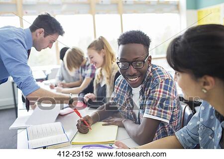 Teacher with his students in classroom View Large Photo Image Stock Image - Teacher with his students in classroom . Fotosearch