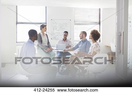 Stock Photography - Team having meeting in modern office. Fotosearch