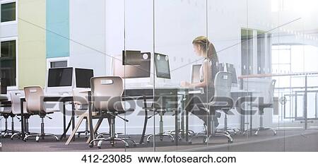 Stock Photography - Teenage girl using computer in computer room. Fotosearch