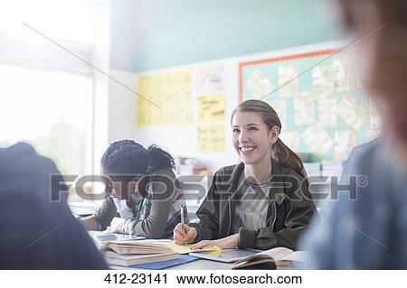Stock Image - Teenage students learning in classroom. Fotosearch