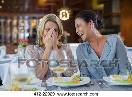 Two mature women laughing in restaurant View Large Photo Image Stock Photo - Two mature women laughing in restaurant. Fotosearch