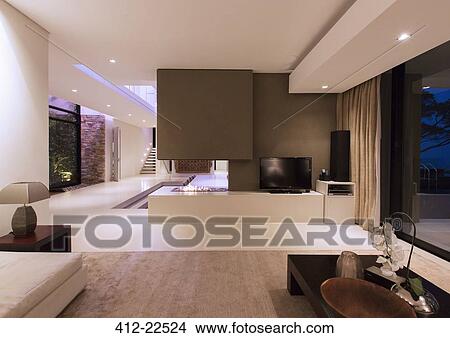 View of fireplace in luxurious living room during night View Large Photo Image Picture - View of fireplace in luxurious living room during night. Fotosearch