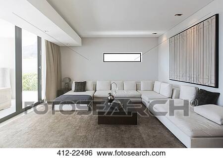 View of modern living room with sofas, coffee table and abstract painting View Large Photo Image Stock Photograph - View of modern living room with sofas, coffee table and abstract painting. Fotosearch