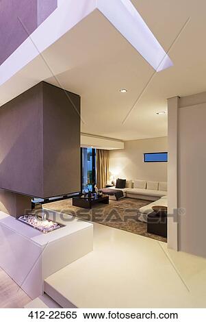 View of spacious modern living room with fireplace during night View Large Photo Image Stock Photography - View of spacious modern living room with fireplace during night. Fotosearch