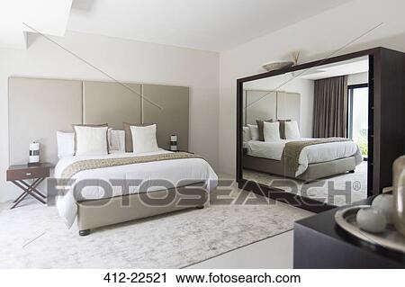White and beige modern bedroom with double bed mirror View Large Photo Image Stock Image - White and beige modern bedroom with double bed mirror. Fotosearch