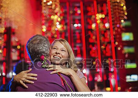 Woman and man embracing in nightclub View Large Photo Image Stock Image - Woman and man embracing in nightclub. Fotosearch
