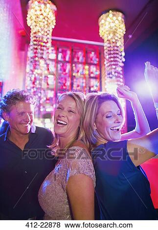 Stock Photo - Women and man dancing in nightclub. Fotosearch