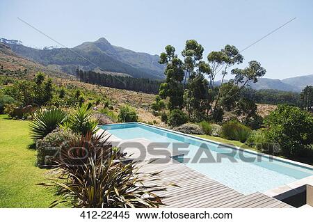 Wooden deck and swimming pool in hilly landscape View Large Photo Image Stock Photography - Wooden deck and swimming pool in hilly landscape. Fotosearch