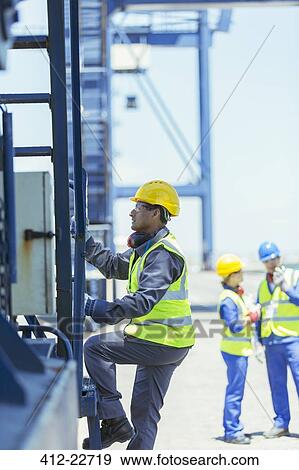 Worker climbing cargo crane View Large Photo Image Stock Photo - Worker climbing cargo crane. Fotosearch
