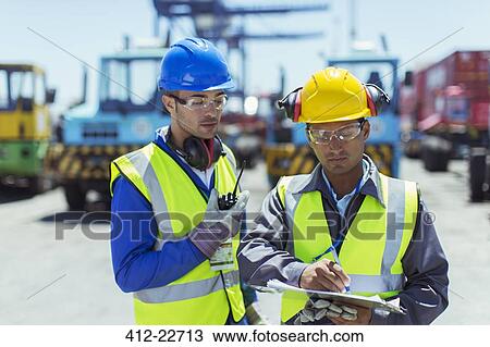 Workers talking near trucks View Large Photo Image Stock Image - Workers talking near trucks. Fotosearch