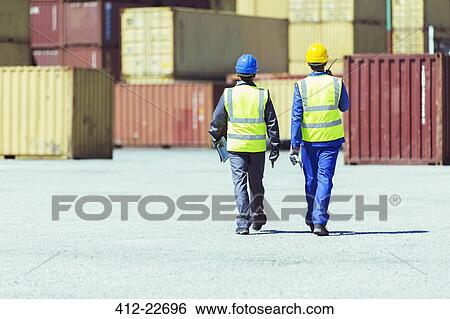Workers walking near cargo containers View Large Photo Image Stock Photograph - Workers walking near cargo containers. Fotosearch