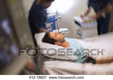 Blurred motion view of patient lying in bed in intensive care unit View Large Photo Image Stock Image - Blurred motion view of patient lying in bed in intensive care unit. Fotosearch