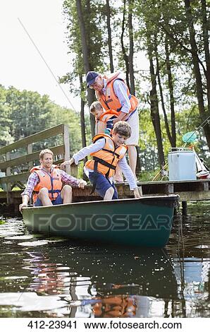 Boy, father and grandfather climbing into canoe View Large Photo Image Stock Image - Boy, father and grandfather climbing into canoe. Fotosearch