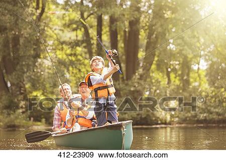 Stock Photo - Boy, father and grandfather fishing from canoe on lake. Fotosearch