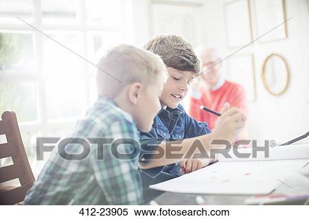 Boys drawing together at table View Large Photo Image Stock Photography - Boys drawing together at table. Fotosearch
