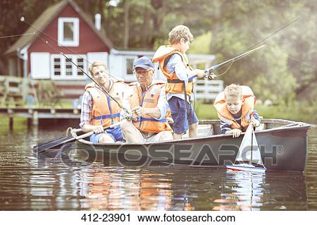 Brothers, father and grandfather fishing from canoe on lake View Large Photo Image Stock Image - Brothers, father and grandfather fishing from canoe on lake. Fotosearch