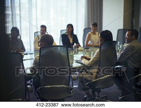 Stock Photo - Business people attending meeting in conference room. Fotosearch