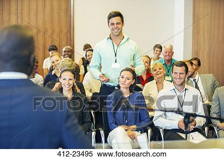 Business people attending presentation in conference room, smiling and discussing View Large Photo Image Stock Photography - Business people attending presentation in conference room, smiling and discussing. Fotosearch