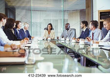 Business people having meeting in in conference room, smiling and discussing View Large Photo Image Stock Photo - Business people having meeting in in conference room, smiling and discussing. Fotosearch