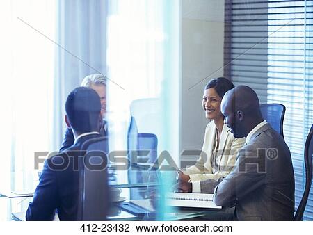 Stock Image - Business people having meeting in conference room. Fotosearch
