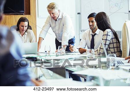 Business people having meeting in conference room, using laptop and discussing View Large Photo Image Stock Photo - Business people having meeting in conference room, using laptop and discussing. Fotosearch