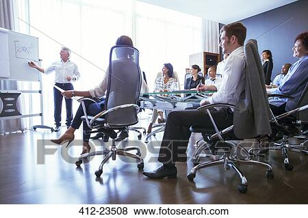 Business people having meeting in conference room, watching colleagues presentation View Large Photo Image Stock Photo - Business people having meeting in conference room, watching colleagues presentation. Fotosearch
