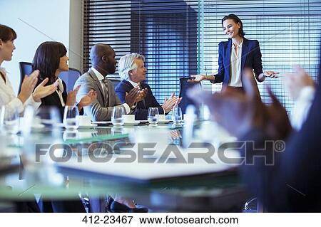 Business people meeting in conference room, woman standing giving speech View Large Photo Image Stock Photo - Business people meeting in conference room, woman standing giving speech. Fotosearch