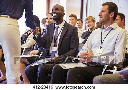 Business people shaking hands during business meeting in conference room View Large Photo Image Stock Photograph - Business people shaking hands during business meeting in conference room. Fotosearch