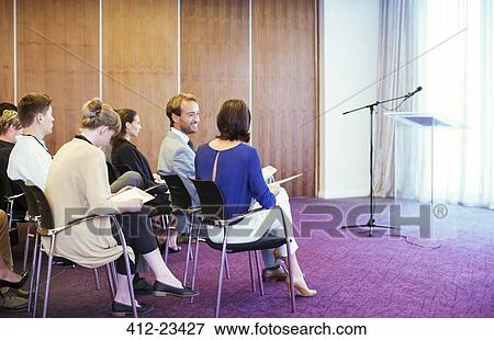 Business people sitting in conference room waiting for presentation View Large Photo Image Stock Photo - Business people sitting in conference room waiting for presentation. Fotosearch