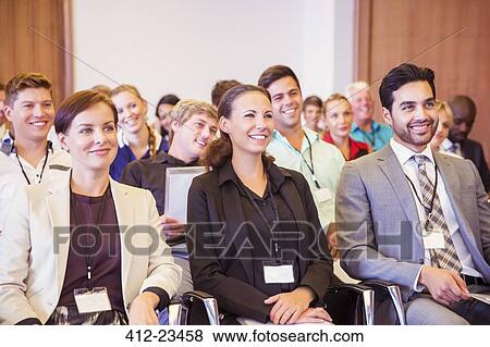 Business people sitting in conference room, smiling and looking away View Large Photo Image Stock Photo - Business people sitting in conference room, smiling and looking away. Fotosearch