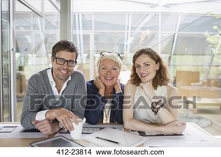 Picture - Business people smiling in office meeting. Fotosearch