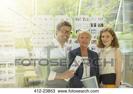 Business people smiling in office View Large Photo Image Stock Image - Business people smiling in office. Fotosearch
