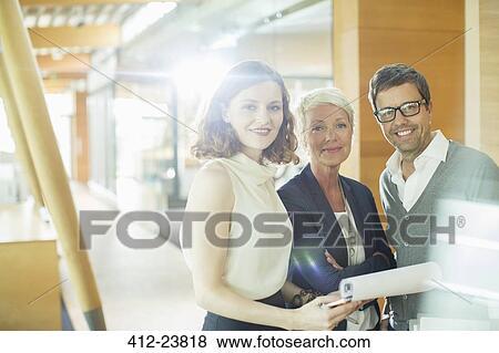 Business people smiling in office View Large Photo Image Stock Photo - Business people smiling in office. Fotosearch