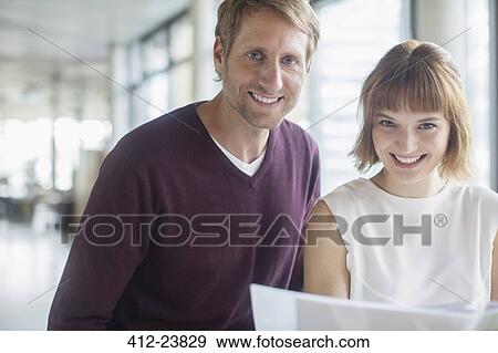 Business people smiling in office View Large Photo Image Stock Photo - Business people smiling in office. Fotosearch