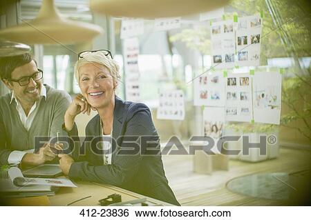 Stock Photograph - Business people smiling in office. Fotosearch