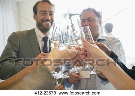 Business people toasting with champagne during meeting View Large Photo Image Stock Photo - Business people toasting with champagne during meeting. Fotosearch