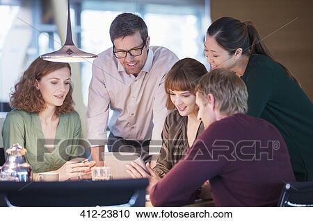Business people using digital tablet in office meeting View Large Photo Image Stock Image - Business people using digital tablet in office meeting. Fotosearch