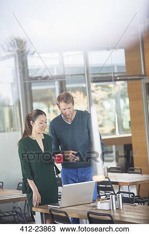 Business people using laptop in cafeteria View Large Photo Image Stock Image - Business people using laptop in cafeteria. Fotosearch