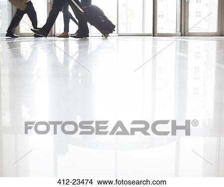 Business people walking in office with suitcases View Large Photo Image Picture - Business people walking in office with suitcases. Fotosearch